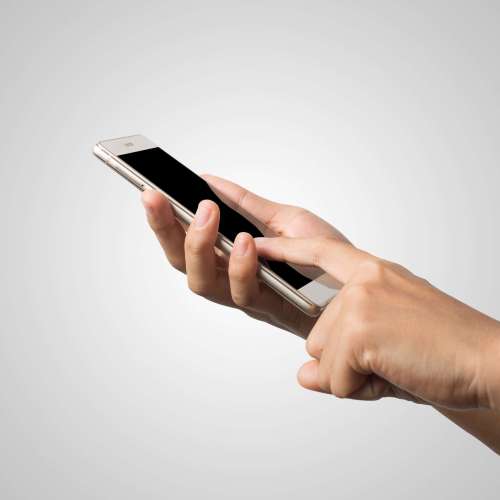 Woman Hand holding smart phone blank screen. Copy space. Hand holding smartphone isolated on white background.